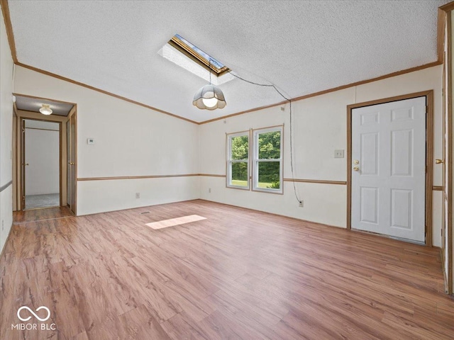 1447 NE Kutenai Trl, Greensburg, IN 47240 - spare room with a skylight, wood finished floors, ornamental molding, and a textured ceiling