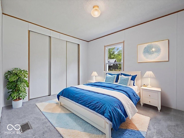 1447 NE Kutenai Trl, Greensburg, IN 47240 - carpeted bedroom with ornamental molding, a closet, and a textured ceiling