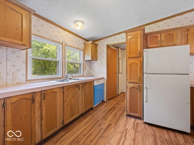 1447 NE Kutenai Trl, Greensburg, IN 47240 - kitchen featuring freestanding refrigerator, wallpapered walls, ornamental molding, dishwasher, and a sink