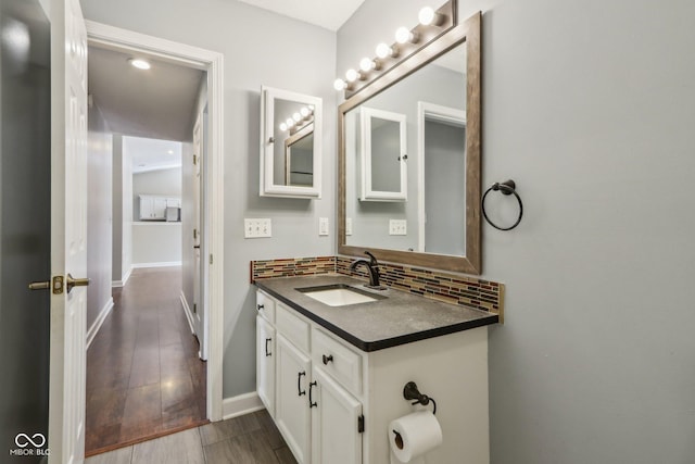 17357 Austrian Pine Way, Westfield, IN 46074 - bathroom with vanity, backsplash, wood finished floors, and baseboards