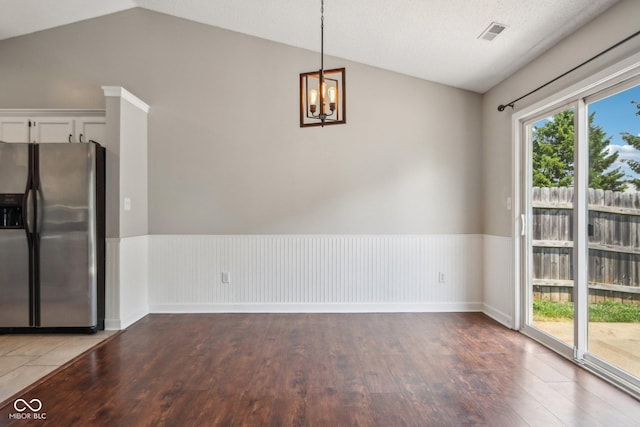 17357 Austrian Pine Way, Westfield, IN 46074 - unfurnished dining area with lofted ceiling, wood finished floors, a chandelier, and wainscoting