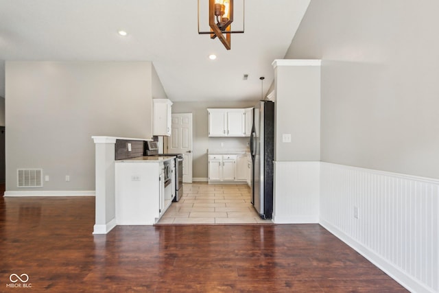 17357 Austrian Pine Way, Westfield, IN 46074 - kitchen with appliances with stainless steel finishes, a chandelier, white cabinetry, light countertops, and lofted ceiling