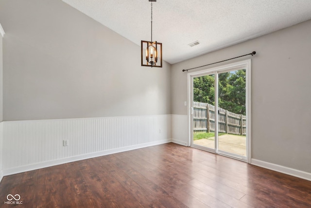 17357 Austrian Pine Way, Westfield, IN 46074 - unfurnished room featuring wood finished floors, a chandelier, a textured ceiling, baseboards, and a wainscoted wall
