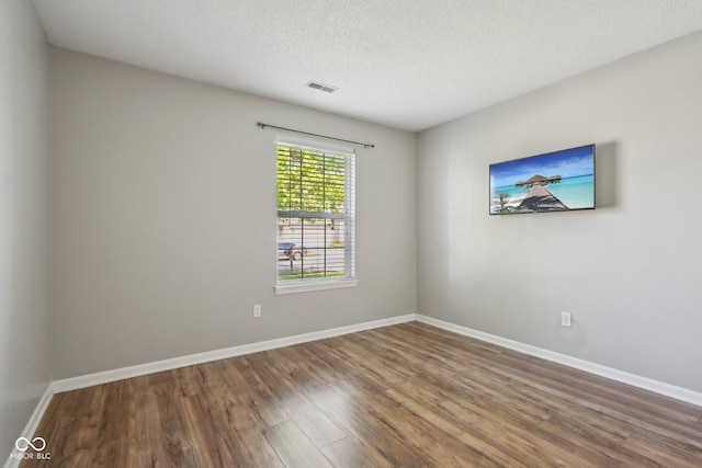 17357 Austrian Pine Way, Westfield, IN 46074 - empty room with wood finished floors, baseboards, and a textured ceiling