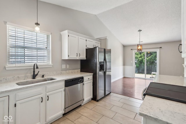 17357 Austrian Pine Way, Westfield, IN 46074 - kitchen featuring stainless steel appliances, a sink, lofted ceiling, white cabinets, and hanging light fixtures