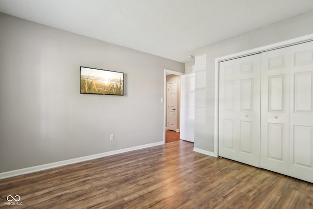 17357 Austrian Pine Way, Westfield, IN 46074 - unfurnished bedroom featuring dark wood finished floors, a closet, and baseboards