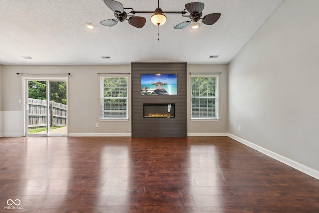 17357 Austrian Pine Way, Westfield, IN 46074 - unfurnished living room with ceiling fan, plenty of natural light, baseboards, and a textured ceiling