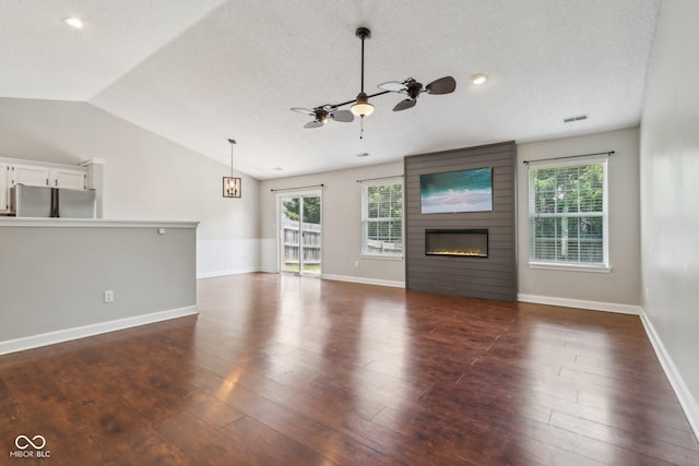 17357 Austrian Pine Way, Westfield, IN 46074 - unfurnished living room with vaulted ceiling, a ceiling fan, a fireplace, healthy amount of natural light, and dark wood-type flooring