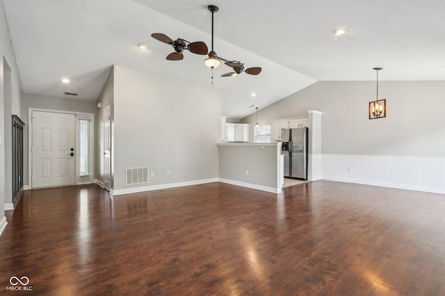 17357 Austrian Pine Way, Westfield, IN 46074 - unfurnished living room featuring lofted ceiling, a ceiling fan, dark wood finished floors, a chandelier, and baseboards