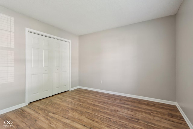 17357 Austrian Pine Way, Westfield, IN 46074 - unfurnished bedroom featuring wood finished floors, baseboards, and a closet