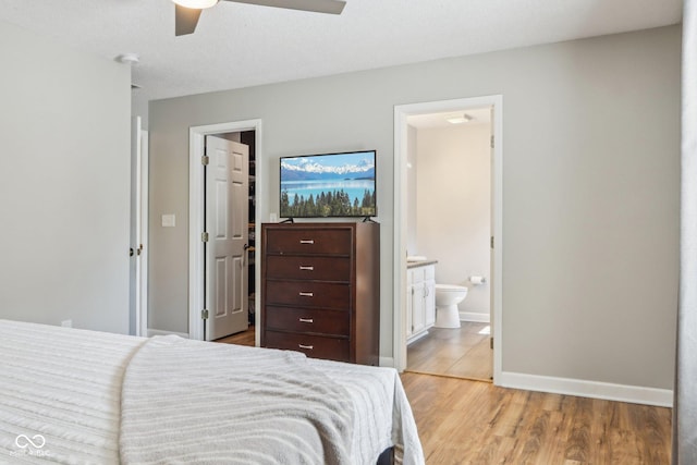 17357 Austrian Pine Way, Westfield, IN 46074 - bedroom with a walk in closet, ensuite bathroom, light wood-style floors, baseboards, and a ceiling fan