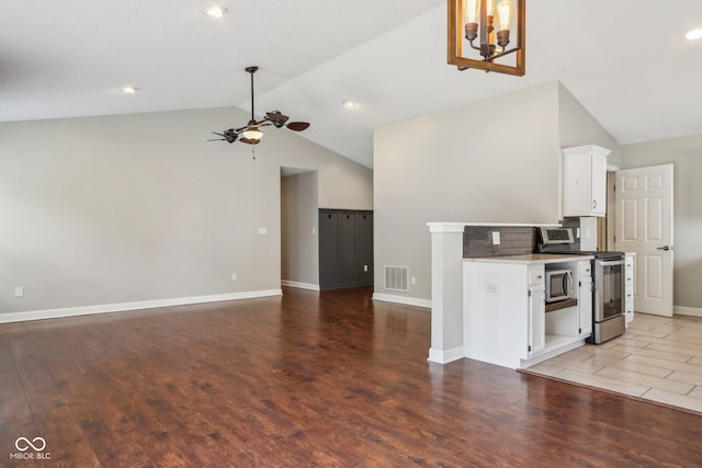 17357 Austrian Pine Way, Westfield, IN 46074 - kitchen with stainless steel appliances, lofted ceiling, ceiling fan, white cabinetry, and baseboards