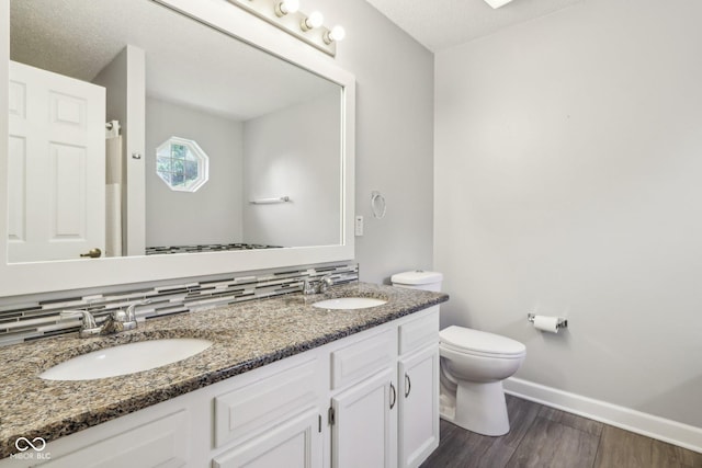17357 Austrian Pine Way, Westfield, IN 46074 - full bathroom featuring wood finished floors, double vanity, toilet, baseboards, and a textured ceiling