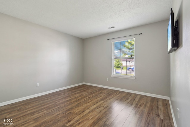 17357 Austrian Pine Way, Westfield, IN 46074 - unfurnished room with dark wood-style floors, baseboards, and a textured ceiling