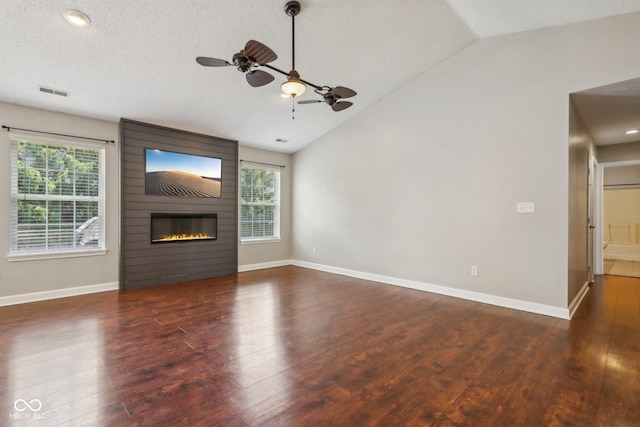 17357 Austrian Pine Way, Westfield, IN 46074 - unfurnished living room with lofted ceiling, plenty of natural light, ceiling fan, wood finished floors, and a fireplace