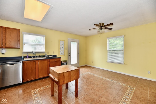 3429 Pavetto Ln, Indianapolis, IN 46203 - kitchen with dishwasher, plenty of natural light, a ceiling fan, and light tile patterned floors