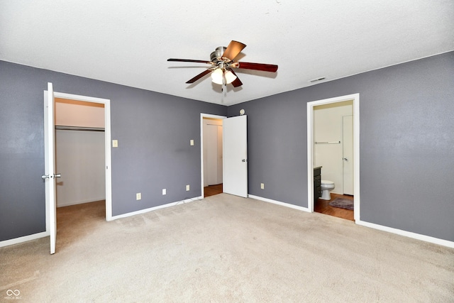 3429 Pavetto Ln, Indianapolis, IN 46203 - unfurnished bedroom featuring carpet floors, a walk in closet, connected bathroom, ceiling fan, and a closet