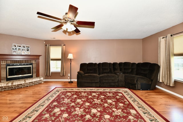 3429 Pavetto Ln, Indianapolis, IN 46203 - living room with wood finished floors, a ceiling fan, and a fireplace