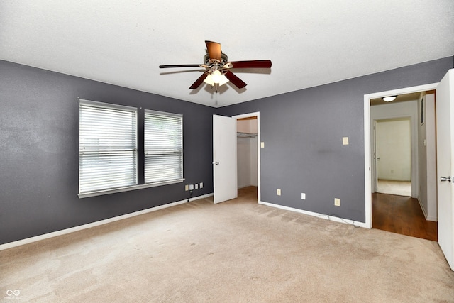 3429 Pavetto Ln, Indianapolis, IN 46203 - unfurnished bedroom with carpet floors, a ceiling fan, a closet, and a spacious closet