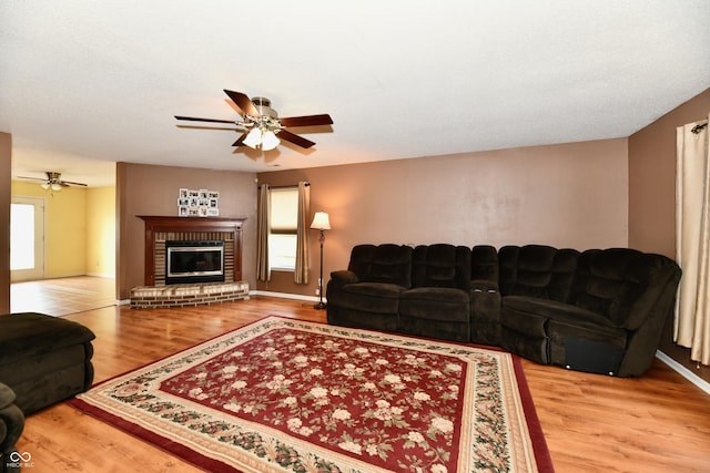 3429 Pavetto Ln, Indianapolis, IN 46203 - living room with ceiling fan, wood finished floors, and a brick fireplace