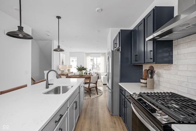 1315 Colere Pl, Indianapolis, IN 46203 - kitchen featuring wall chimney range hood, a sink, appliances with stainless steel finishes, and light countertops