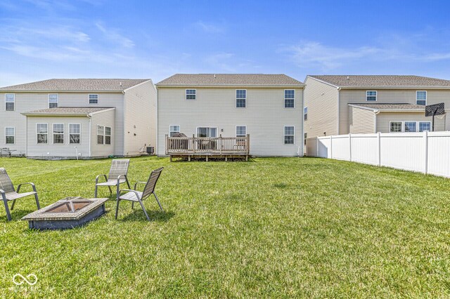 back of property featuring an outdoor fire pit and a deck