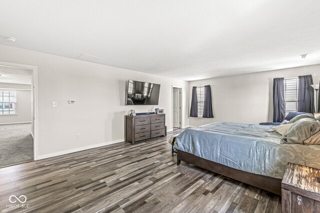bedroom featuring wood finished floors and baseboards