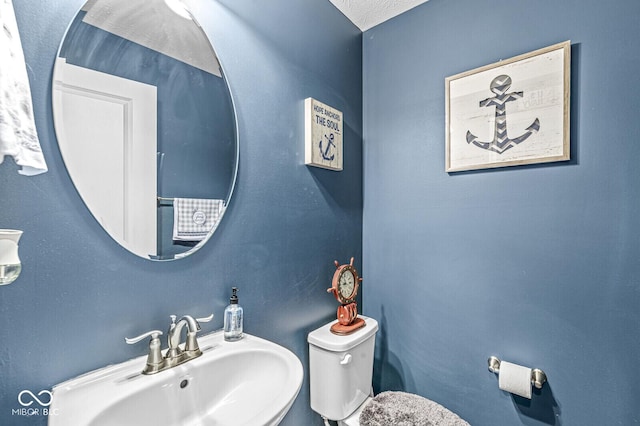 half bathroom with a sink and toilet