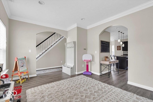 2434 Burgundy Way, Plainfield, IN 46168 - interior space with wood finished floors, baseboards, crown molding, arched walkways, and stairway