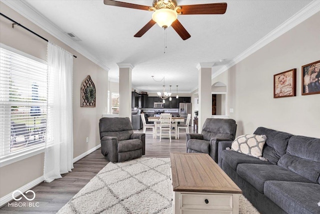 2434 Burgundy Way, Plainfield, IN 46168 - living area with a chandelier, ornamental molding, wood finished floors, a ceiling fan, and baseboards
