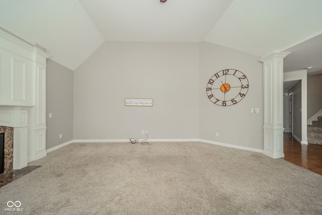 10555 Serra Vista Pt, Fishers, IN 46040 - unfurnished living room with carpet flooring, stairway, ornate columns, vaulted ceiling, and a high end fireplace