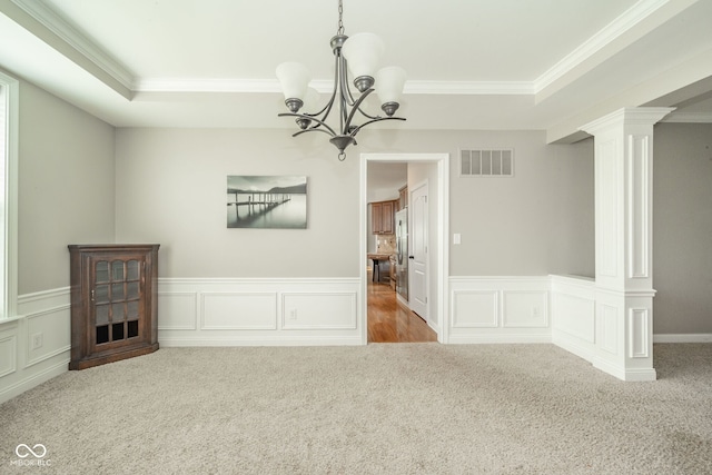10555 Serra Vista Pt, Fishers, IN 46040 - unfurnished dining area featuring a chandelier, ornamental molding, carpet flooring, a decorative wall, and a tray ceiling