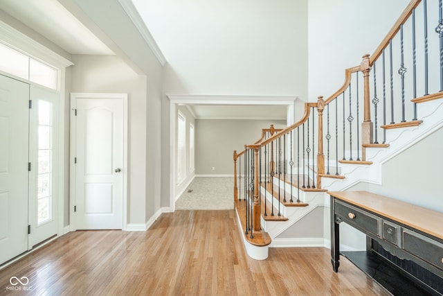 10555 Serra Vista Pt, Fishers, IN 46040 - foyer entrance featuring light wood-type flooring, stairs, and baseboards