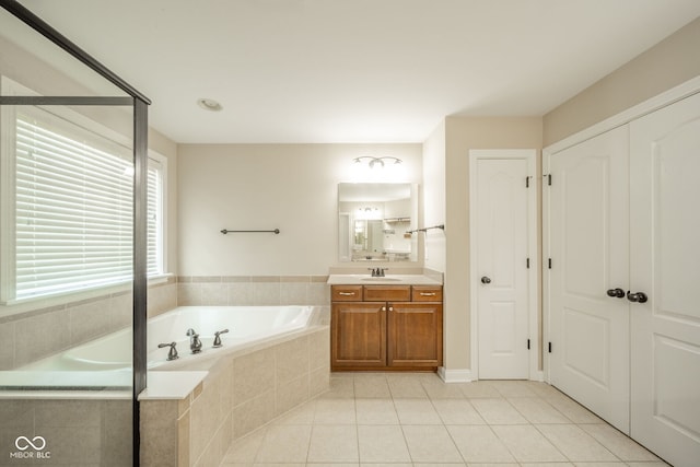 10555 Serra Vista Pt, Fishers, IN 46040 - bathroom featuring vanity, a garden tub, and tile patterned floors