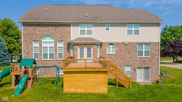10555 Serra Vista Pt, Fishers, IN 46040 - rear view of property featuring brick siding, a lawn, and a playground