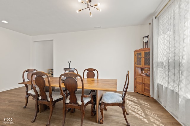 1026 Sorrell Pass, Greenwood, IN 46143 - dining space with a chandelier, light wood-type flooring, and baseboards