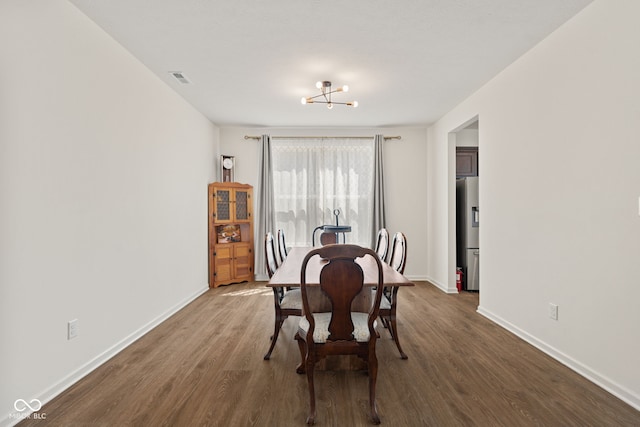 1026 Sorrell Pass, Greenwood, IN 46143 - dining room with dark wood-style flooring, baseboards, and a chandelier