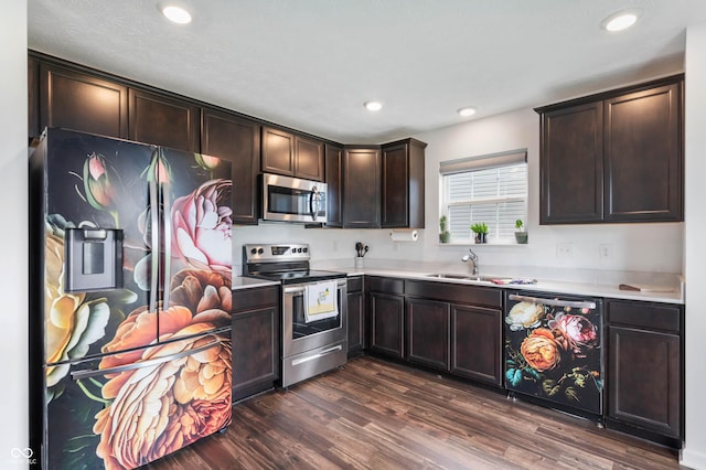 5794 Wintersweet Ln, Whitestown, IN 46075 - kitchen featuring appliances with stainless steel finishes, a sink, dark brown cabinets, dark wood-style flooring, and light countertops
