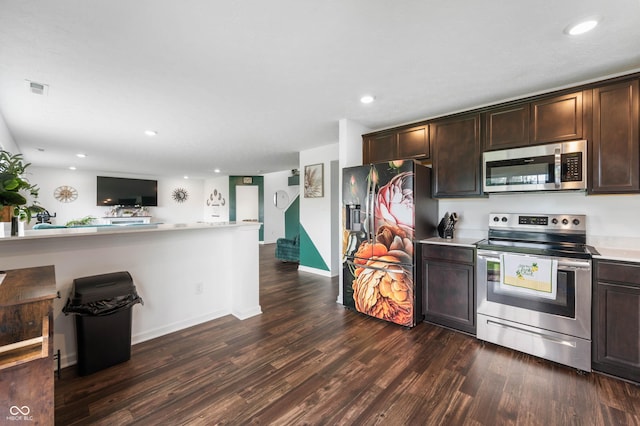 5794 Wintersweet Ln, Whitestown, IN 46075 - kitchen with appliances with stainless steel finishes, dark brown cabinetry, light countertops, dark wood-style flooring, and recessed lighting