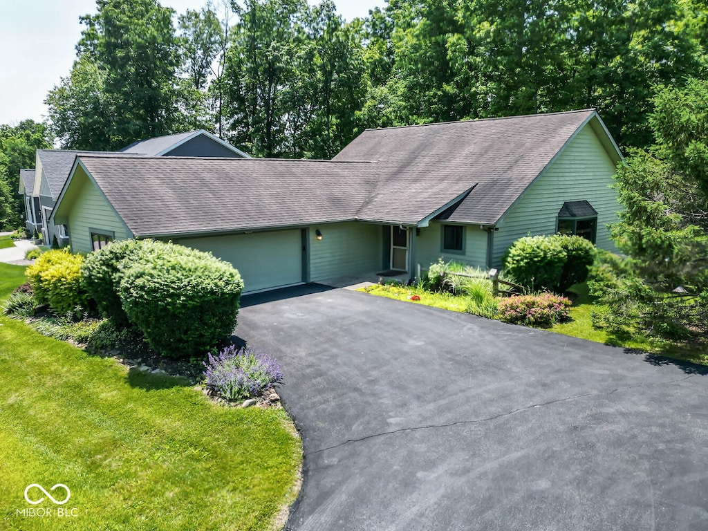 115 Pine Hills Dr, Nashville, IN 47448 - single story home featuring an attached garage, asphalt driveway, and a shingled roof