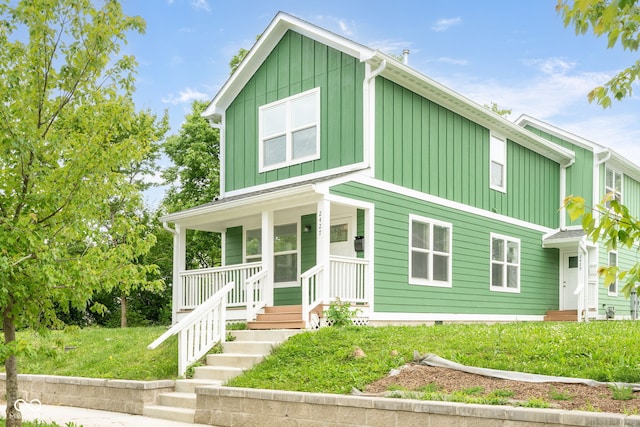 2427 N Rural St, Indianapolis, IN 46218 - view of front of property featuring board and batten siding, a porch, and a front yard