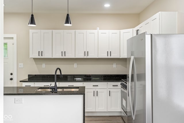 2427 N Rural St, Indianapolis, IN 46218 - kitchen featuring freestanding refrigerator, a sink, white cabinetry, pendant lighting, and recessed lighting