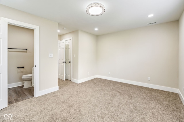 2427 N Rural St, Indianapolis, IN 46218 - unfurnished bedroom featuring carpet floors, baseboards, recessed lighting, and ensuite bath