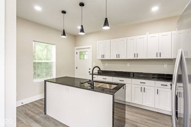 2427 N Rural St, Indianapolis, IN 46218 - kitchen featuring a sink, stainless steel fridge, white cabinetry, dark stone counters, and recessed lighting