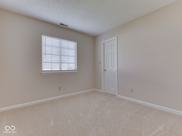 824 Ashton Park Dr, Greenwood, IN 46143 - empty room featuring light carpet, baseboards, and a textured ceiling