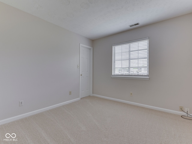 824 Ashton Park Dr, Greenwood, IN 46143 - empty room with baseboards, light carpet, and a textured ceiling