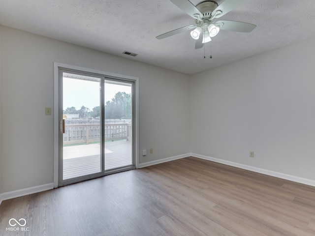 824 Ashton Park Dr, Greenwood, IN 46143 - empty room featuring a ceiling fan, wood finished floors, baseboards, and a textured ceiling