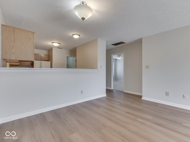 824 Ashton Park Dr, Greenwood, IN 46143 - empty room with light wood-style floors, a textured ceiling, and baseboards
