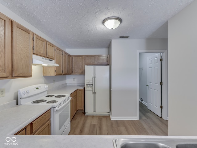 824 Ashton Park Dr, Greenwood, IN 46143 - kitchen featuring white appliances, under cabinet range hood, light wood-style flooring, light countertops, and a textured ceiling