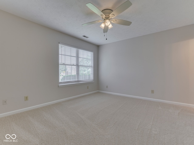 824 Ashton Park Dr, Greenwood, IN 46143 - spare room featuring light colored carpet, baseboards, ceiling fan, and a textured ceiling